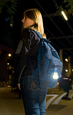 girl with reflector attached to rucksack